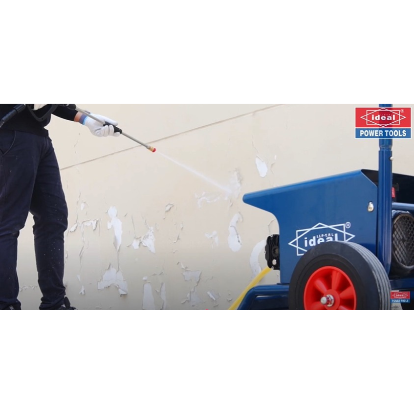 Person using a pressure washer on a wall with Ideal Power Tools branding.